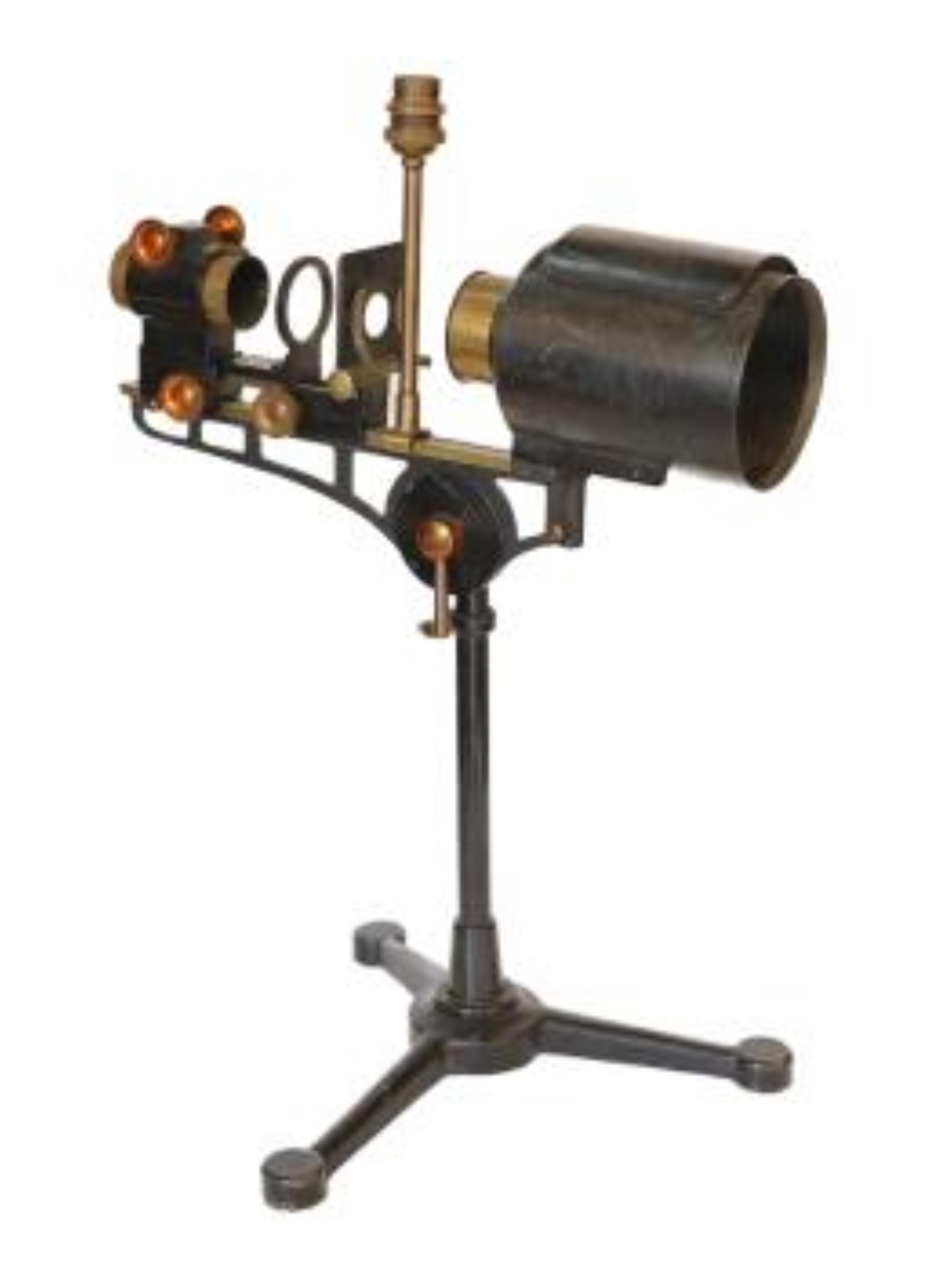 An early 20th century Hatters & Garnett Ltd black lacquered and brass microscope slide projector table lamp (conversion), height 57cm. Condition - fair to good